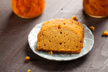 Fototapeta na wymiar Homemade Pumpkin Bread slices on top of blue plate, dark wooden background