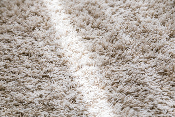 beige color domestic carpet texture with light spot from window