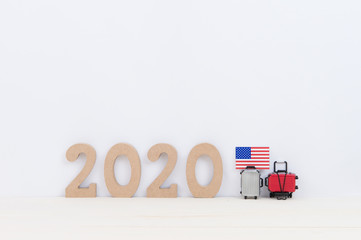 Miniature suitcase , National flag and 2020 on white background