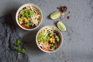Mexican chicken tortilla soup with corn, beans and avocado. Delicious lunch, top view