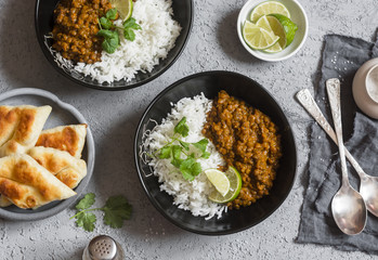 Cream coconut lentil curry with rice and naan bread - vegetarian lunch. Top view, flat lay. Vegetarian healthy food concept