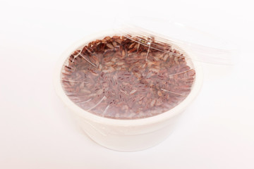 Steamed germinated red rice in plastic package ready to eat, just remove the plastic cap.