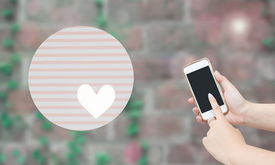 a woman's hand using smart phone with sweet lovely blurry background