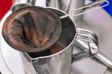 make old coffee bag , pot With tool . Street food and drink Thailand .