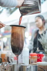 make old coffee bag , pot With tool . Street food and drink Thailand .