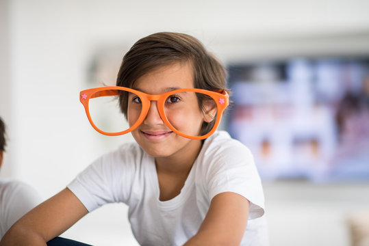 Funny Kids With Silly Glasses On Eyes At Home