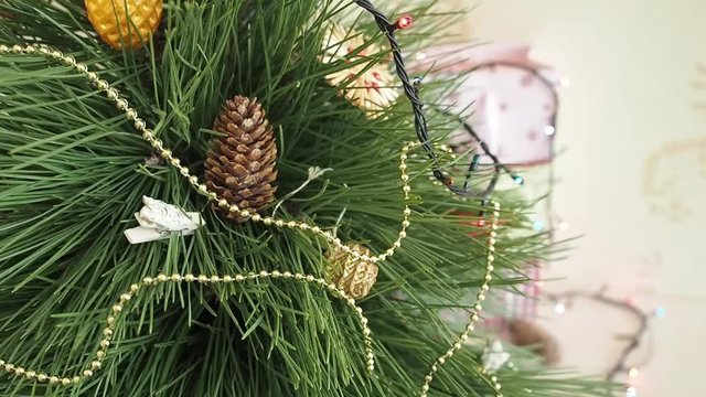 Man decorates a Christmas tree. Hanging Ornaments on a Christmas tree. Concept of holidays and new year