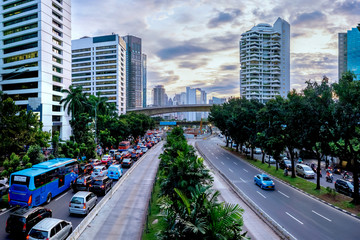 Vehicle traffic jam  in Jakarta main road, Sudirman Street,  Jakarta, at afternoon, Also showing row of beautiful skyscrapper in the side of the road. Urban Skyline, Building Exterior, Capital Cities