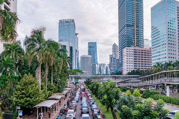 Vehicle traffic jam  in Jakarta main road, Sudirman Street,  Jakarta. Also showing row of beautiful skyscrapper in the side of the road. Urban Skyline, Building Exterior, Capital Cities