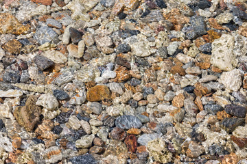 bright multi colored pebbles on the seabed