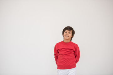 Cute school kid posing in studio with different facial expressio