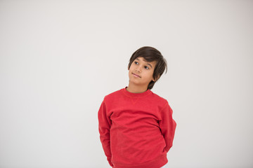 Cute school kid posing in studio with different facial expressio