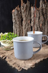 two cups of coffee on the wooden background