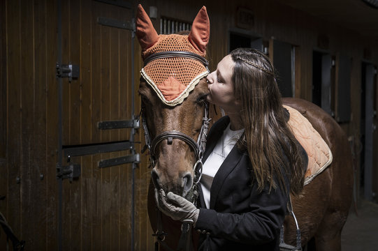 Woman kissing her horse