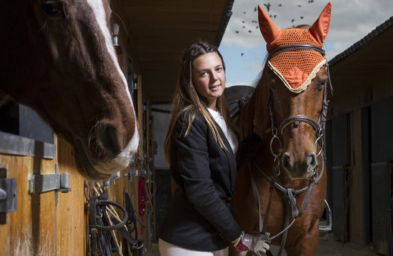 Woman with horse in a stable