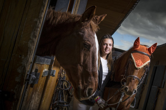 Woman with horse in a stable