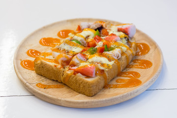 Seafood pizza in wood dish