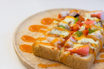 Seafood pizza in wood dish