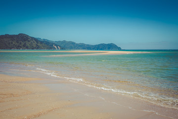 Beautiful dreamy ocean landscape with clear sky and gentle waves of the ocean, Abel Tasman National Park, New Zealand