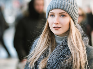 Portrait of young woman at sunny winter day.