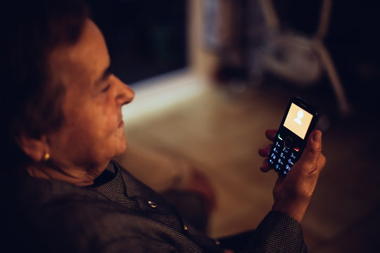 ld woman looking at phone screen