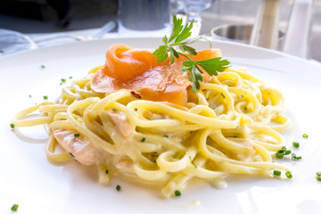 tasty pasta with salmon on a the table