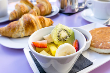 Breakfast with coffee and croissants on table