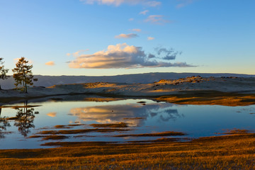 Sunset on the lake reflection of trees in water, Olkhon, Lake Ba
