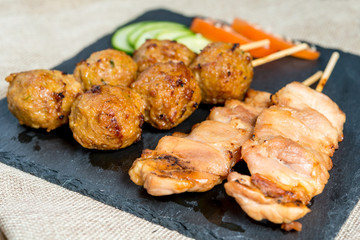 tasty grilled meat and vegetables skewers on a slate plate