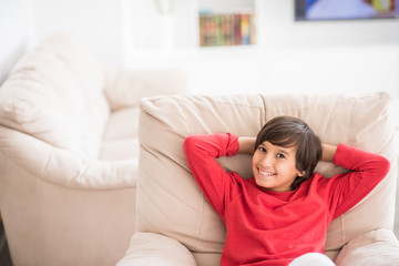 Naklejka premium Kid relaxed on sofa
