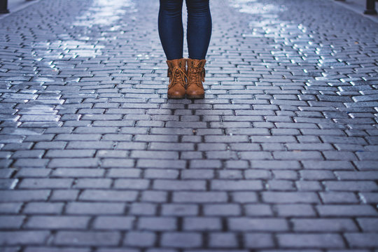 Feet of person on the road
