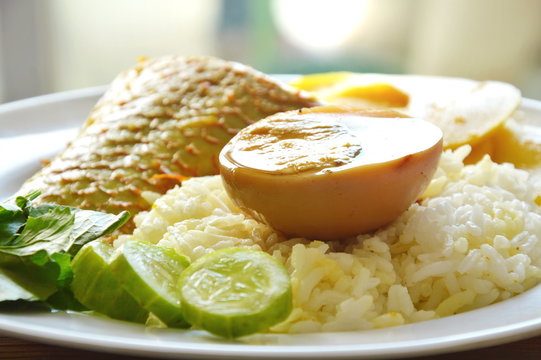 boiled brown egg with mango fish bamboo shoot in spicy and sour soup on rice