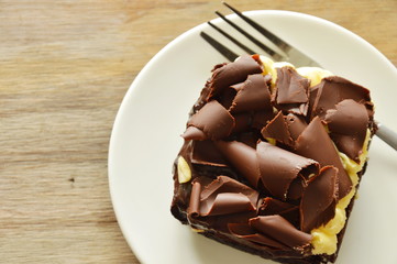 chocolate butter cake topping slicing chocolate and fork on dish