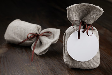cloth bag with a gift, a pleasant surprise on dark baground