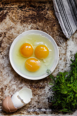 three broken eggs in a plate



