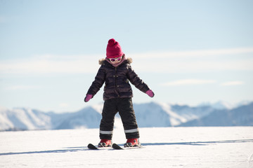 happy little girl skiing downhill