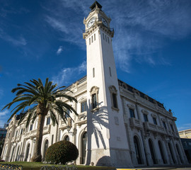 Port Authority buildings with clock tower in Valencia harbor, Spain, ultra wide angle