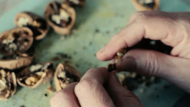 Female hand cut up walnuts