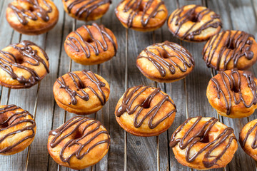 Chocolate donuts on wooden table