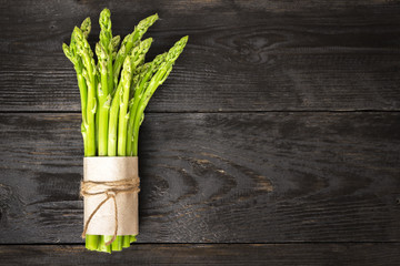 Bunch of fresh asparagus on a rustic wooden table - obrazy, fototapety, plakaty