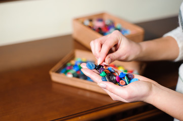 colorful sewing buttons in the hands
