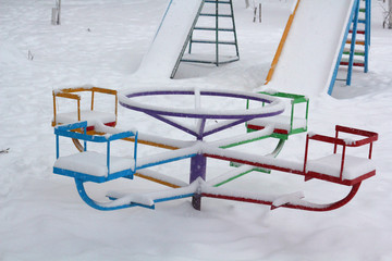 Naklejka premium Swing in In the snow. Winter. Bright. Cheerful. Fun.