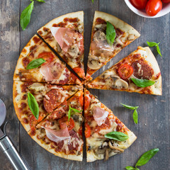 Pizza with salami, mushrooms and herbs