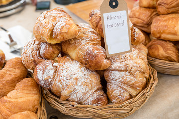 stack of almond croissant on weave basket