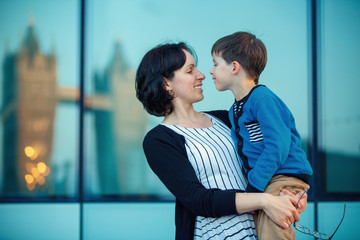 Loving mother and son hugging outdoors