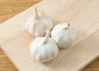Top View of Garlic Bulbs on A Wooden Cutting Board