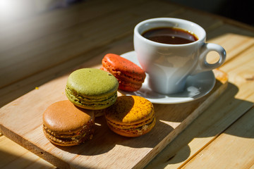 Cup of coffee with cookie on table, closeup