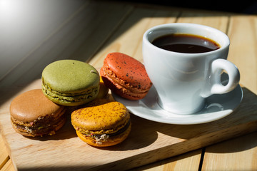 Cup of coffee with cookie on table, closeup
