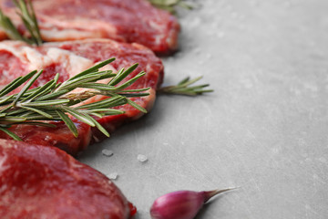 Raw steak with spices on table