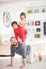 Fototapeta na wymiar Happy father and kids at new modern home